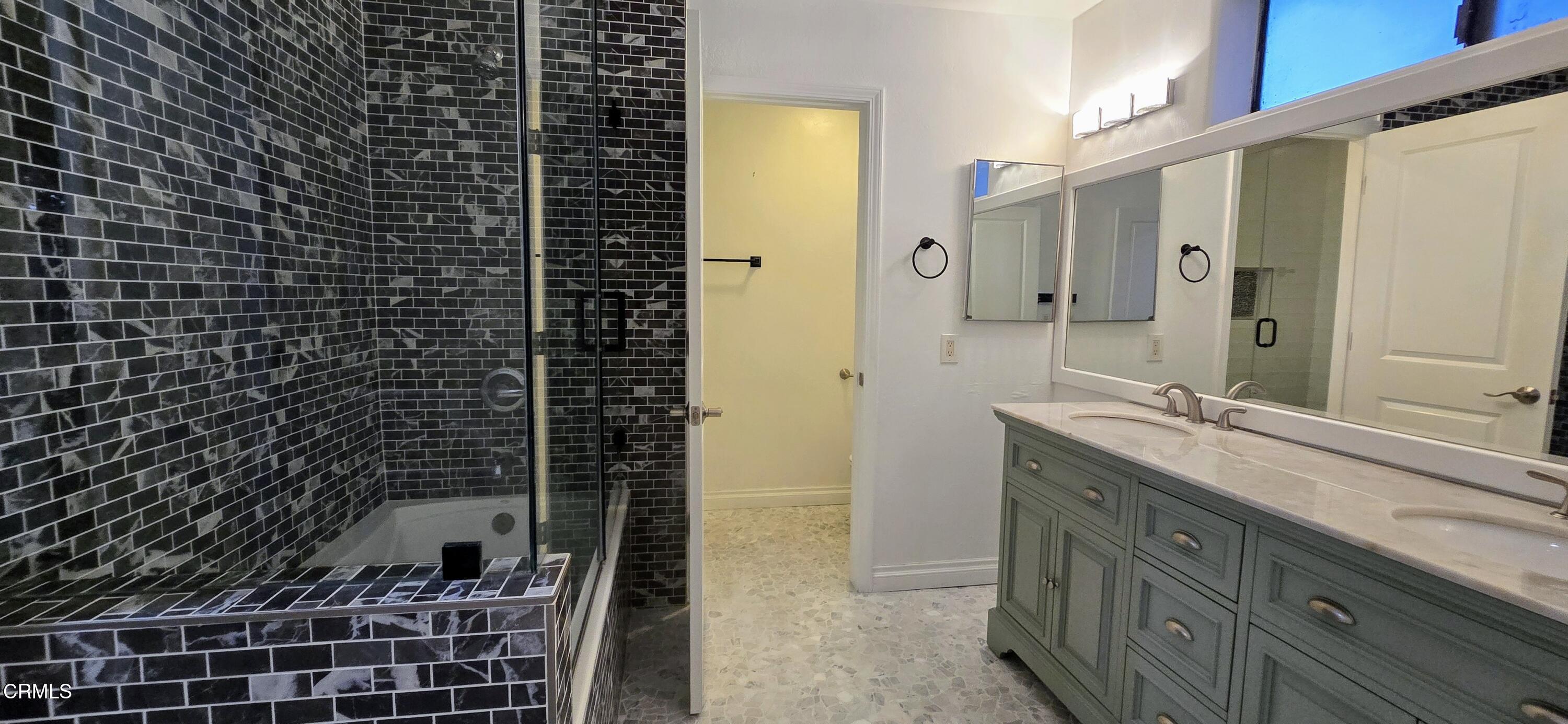 3701 Via Pacifica Walk Oxnard, CA 93035 - Photo 15 of 49 a bathroom with a double vanity sink a toilet and a mirror