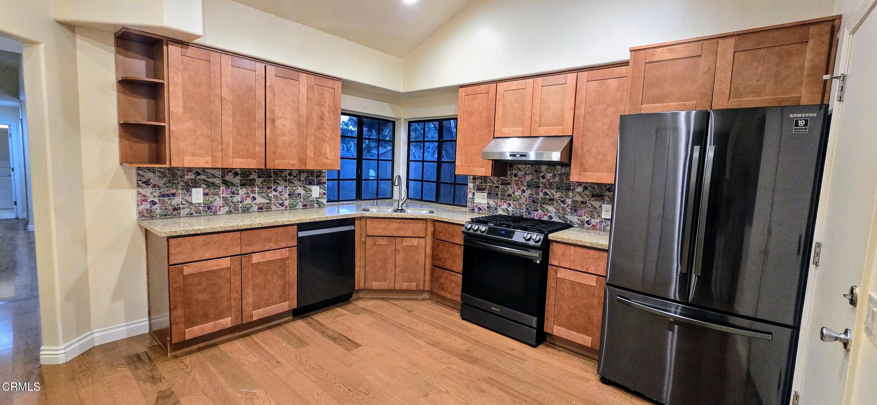 3701 Via Pacifica Walk Oxnard, CA 93035 - Photo 16 of 49 a kitchen with stainless steel appliances granite countertop a refrigerator stove and sink