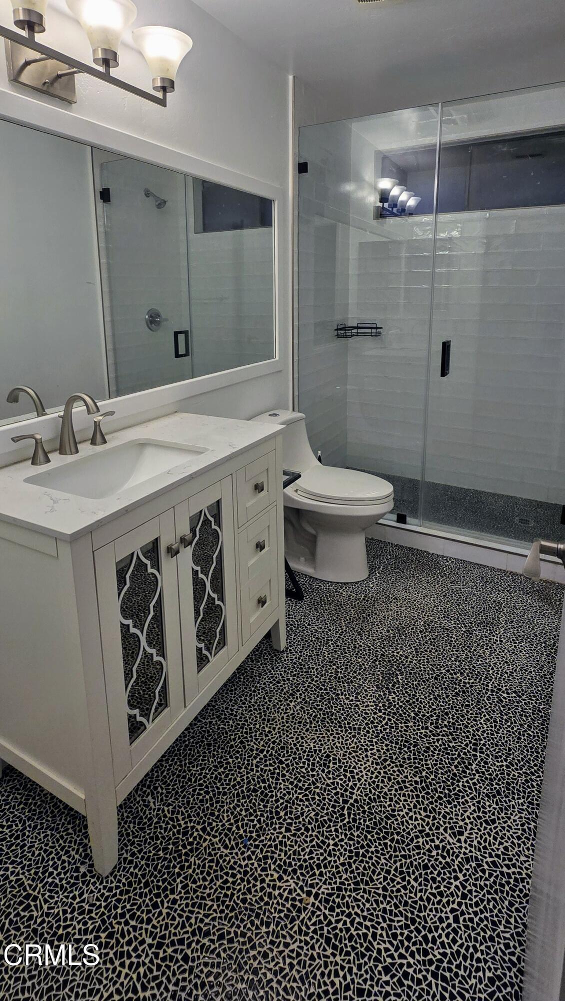 3701 Via Pacifica Walk Oxnard, CA 93035 - Photo 22 of 49 a bathroom with a sink a toilet a mirror and shower