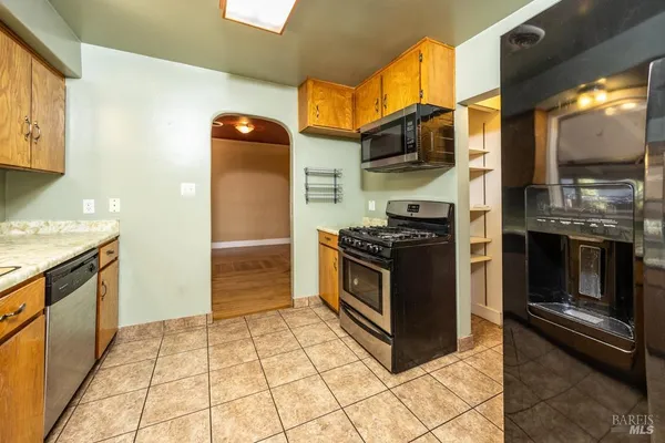 a kitchen with stainless steel appliances granite countertop a stove a microwave and a refrigerator