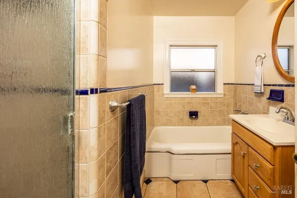 a bathroom with a sink a mirror and a shower