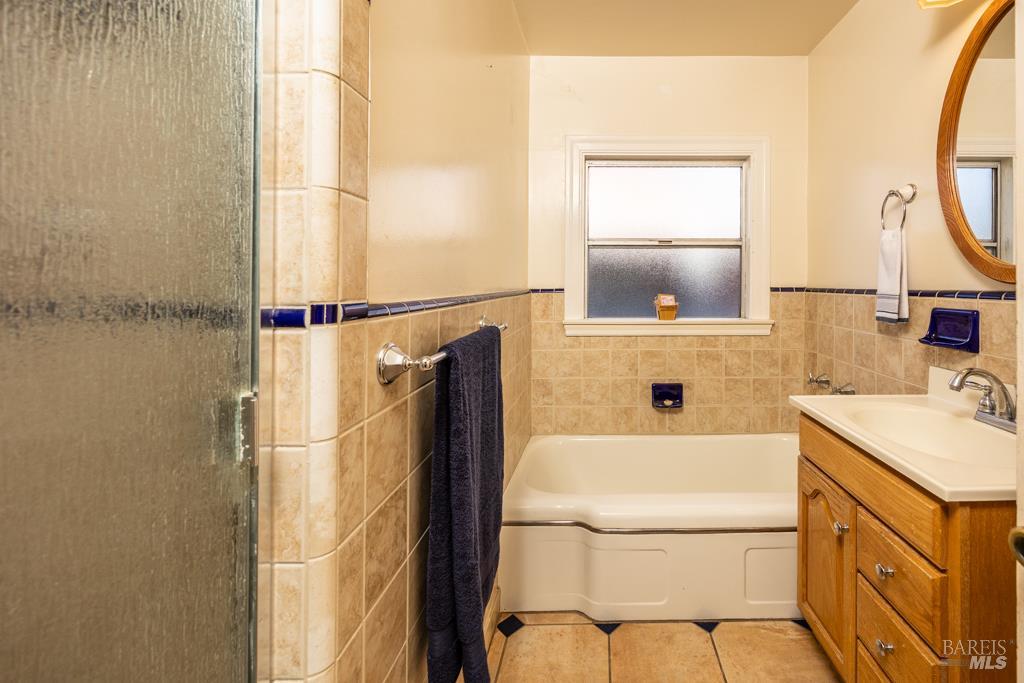 165 Luce Avenue Ukiah, CA 95482 - Photo 14 of 26 a bathroom with a sink vanity mirror and tub