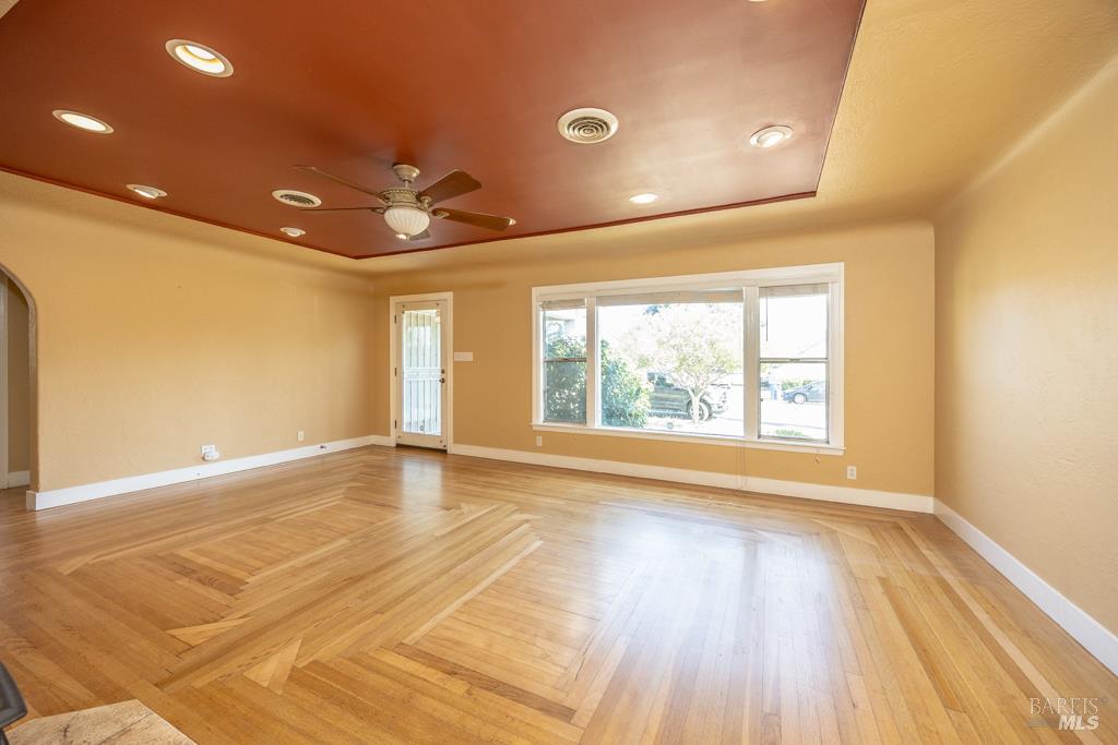 165 Luce Avenue Ukiah, CA 95482 - Photo 4 of 26 a view of an empty room with a window and wooden floor