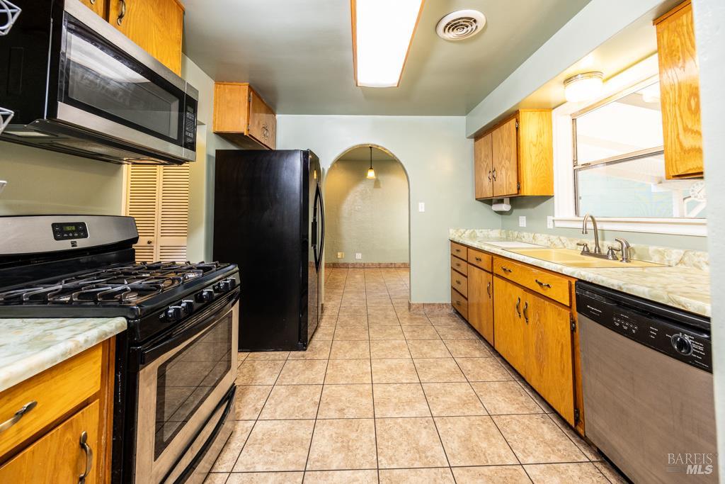 165 Luce Avenue Ukiah, CA 95482 - Photo 10 of 26 a kitchen with stainless steel appliances granite countertop a stove a sink and a microwave