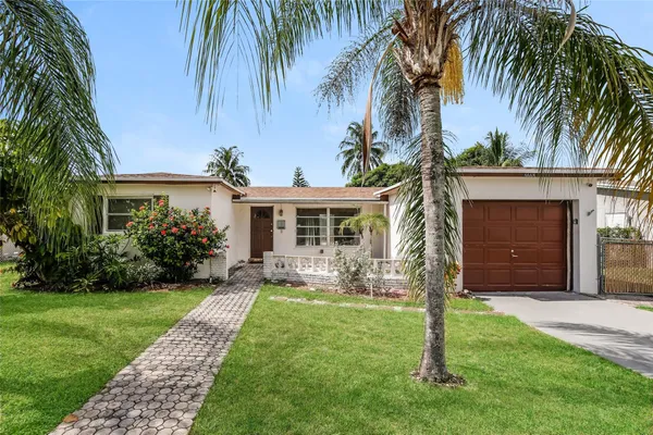 a front view of house with yard and green space