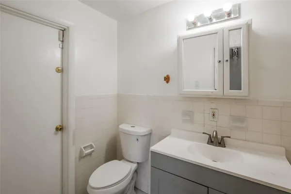 a bathroom with a sink a toilet and mirror