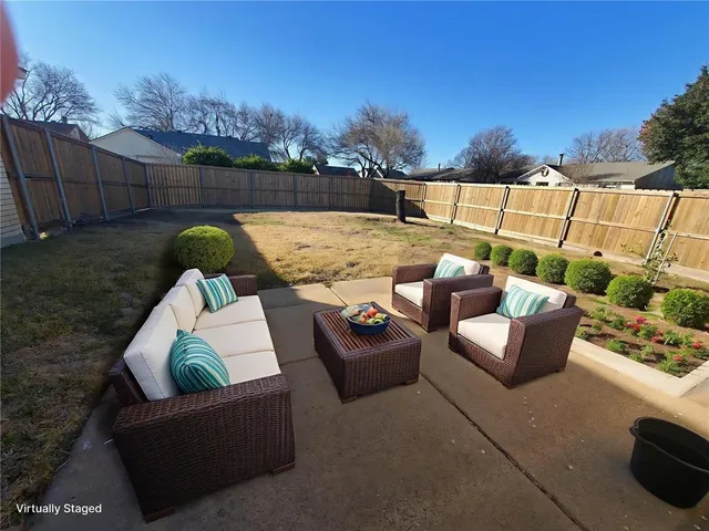 a roof deck with couches and wooden floor