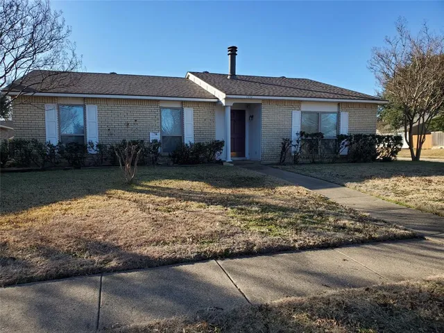 a front view of a house with yard patio and lake view