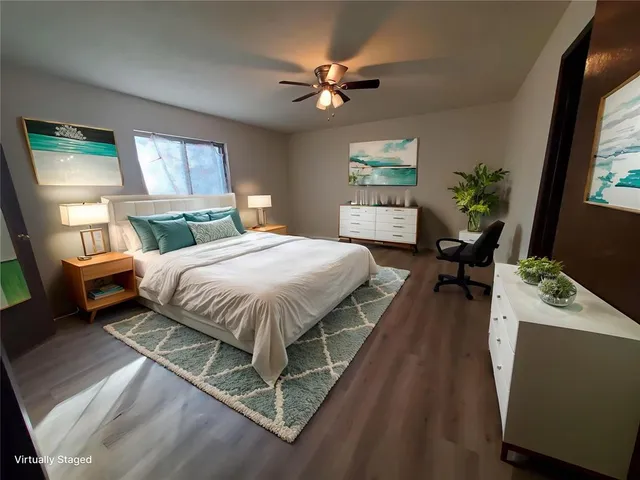 a bedroom with a bed potted plant with the outer view