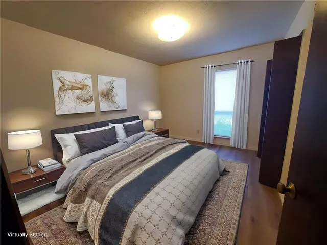 a bedroom with bed and window