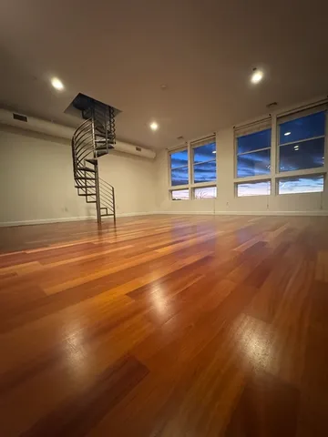 a view of a room with wooden floor