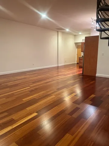 a view of a room with wooden floor