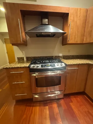 a stove top oven sitting inside of a kitchen