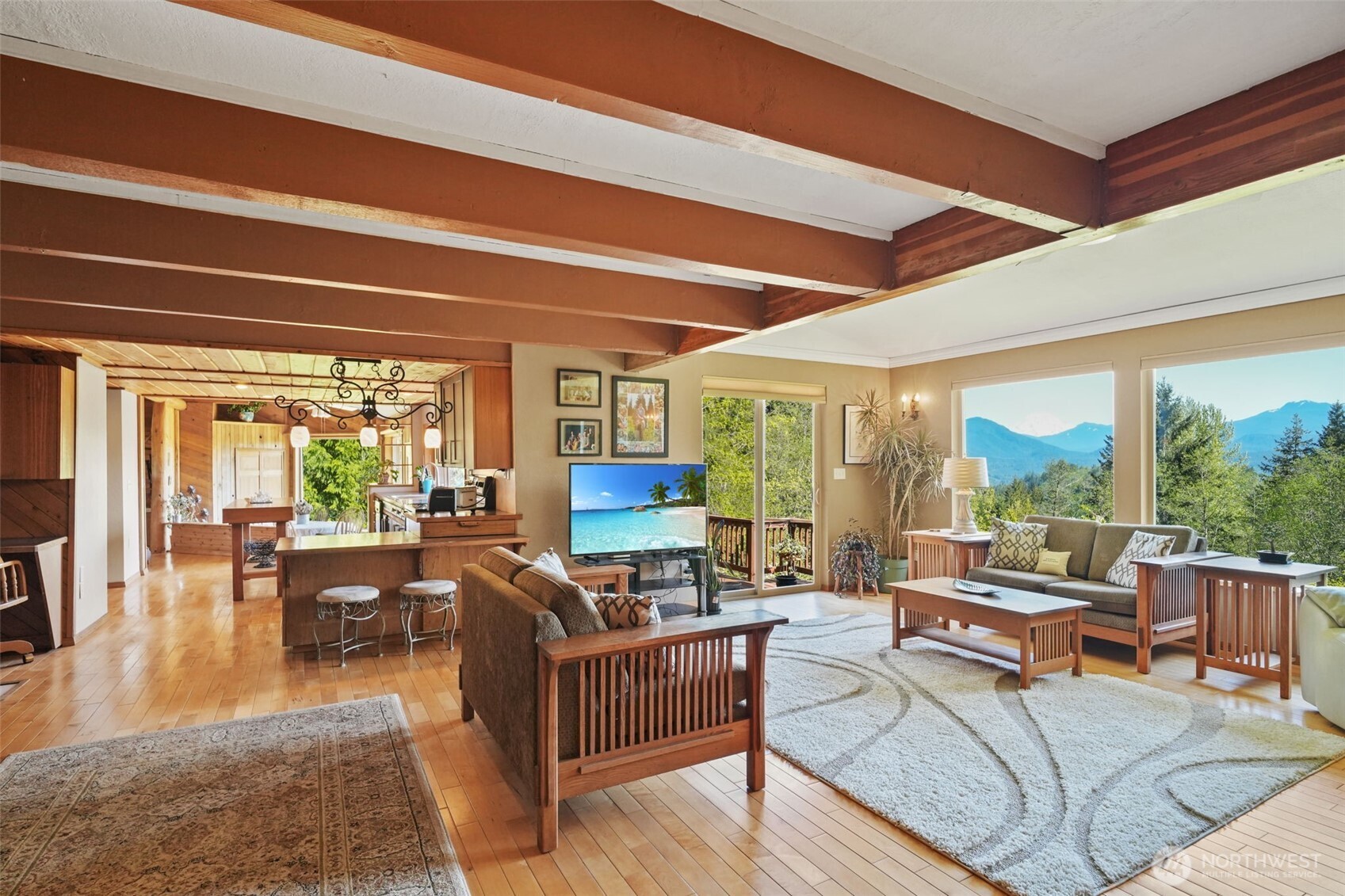 289 Long And Winding Road Randle, WA 98377 - Photo 12 of 40 a living room with furniture a large window and wooden floor