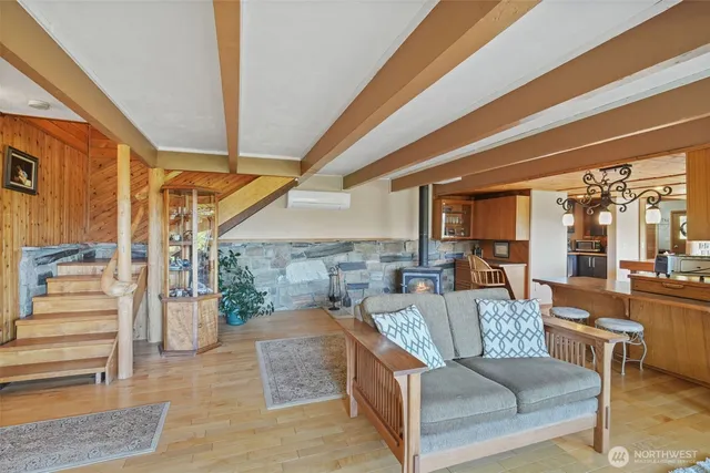 a living room with furniture and a view of bedroom