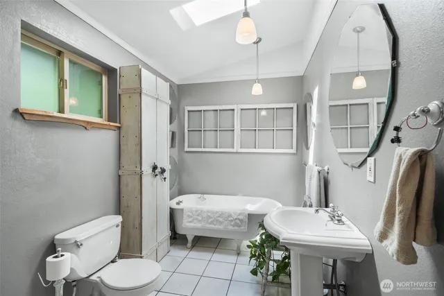 a bathroom with a sink toilet and a mirror