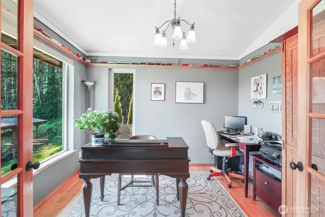 a view of a workspace with furniture and a window