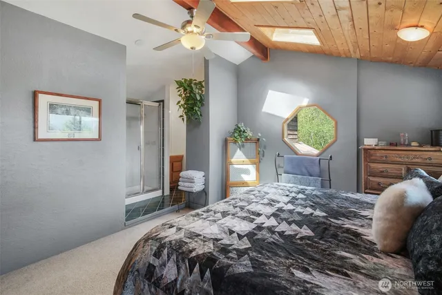 a bedroom with a bed window and dresser
