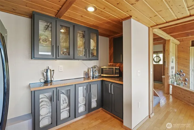 a kitchen that has a lot of windows in it