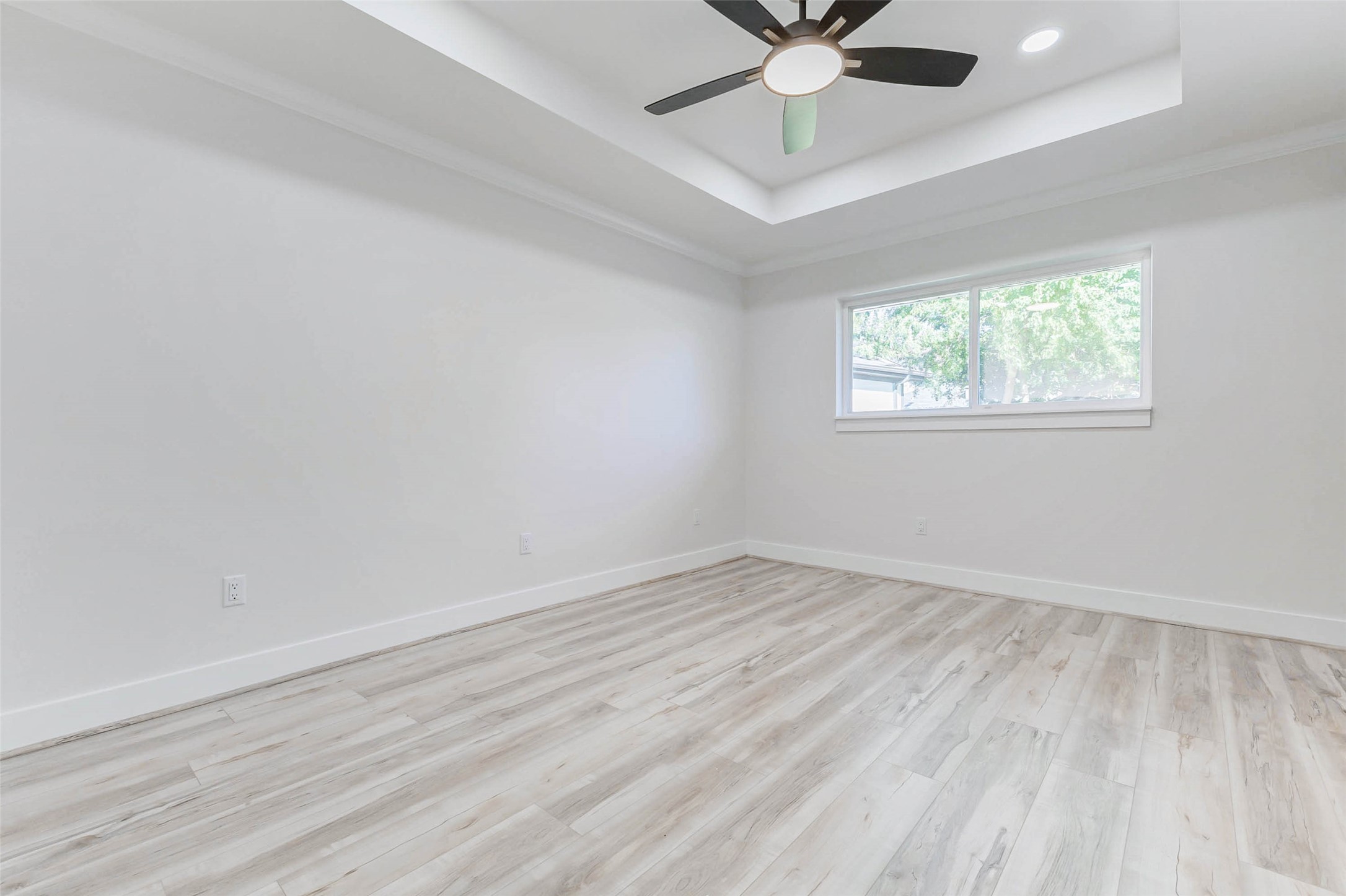 6106 Rutherglenn Drive Houston, TX 77096 - Photo 22 of 43 an empty room with a window and a fan
