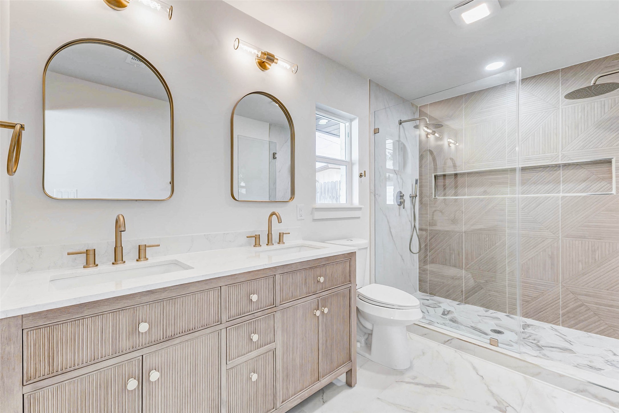 6106 Rutherglenn Drive Houston, TX 77096 - Photo 26 of 43 a bathroom with double vanity a toilet a double vanity and a mirror
