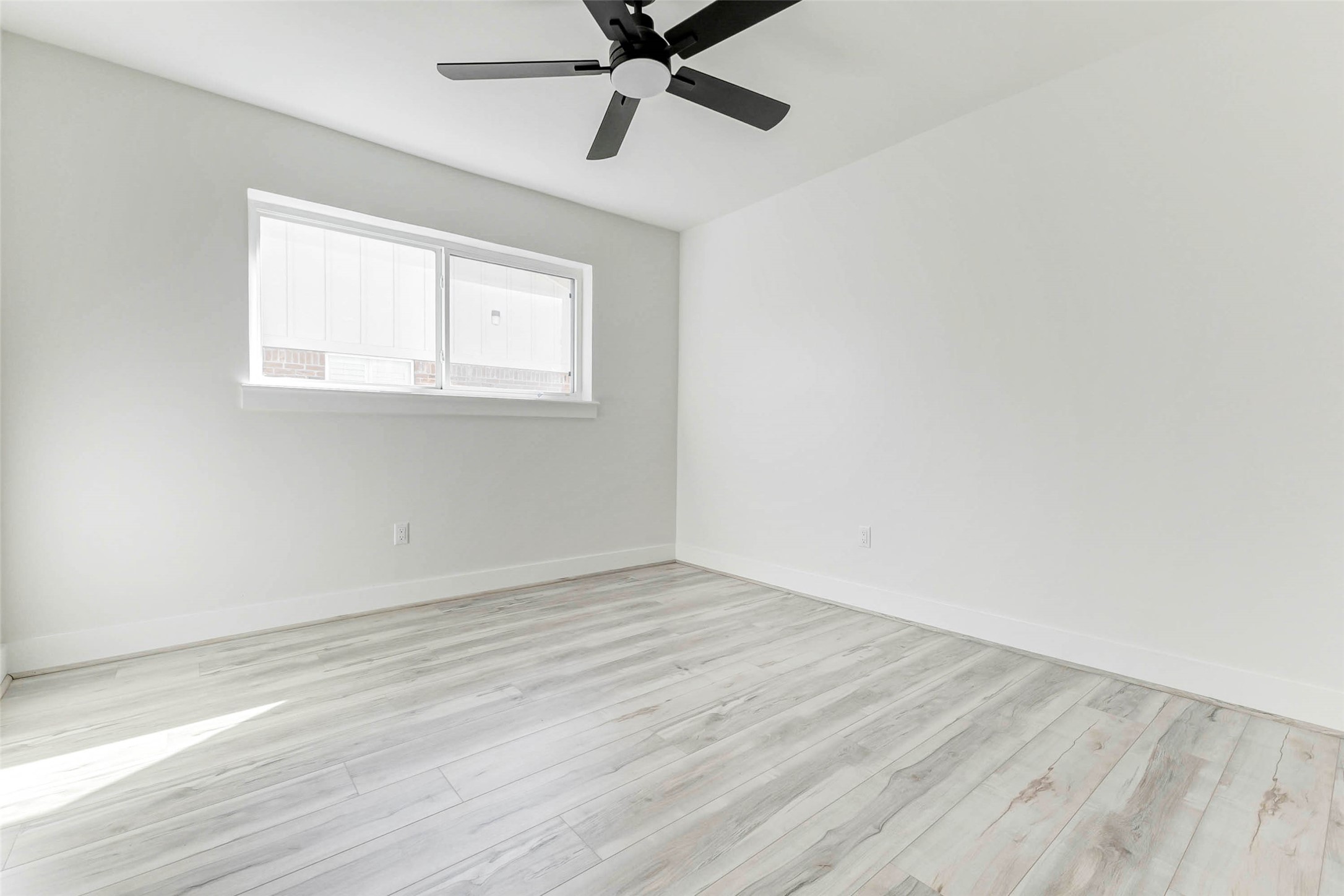 6106 Rutherglenn Drive Houston, TX 77096 - Photo 32 of 43 wooden floor in an empty room with a window