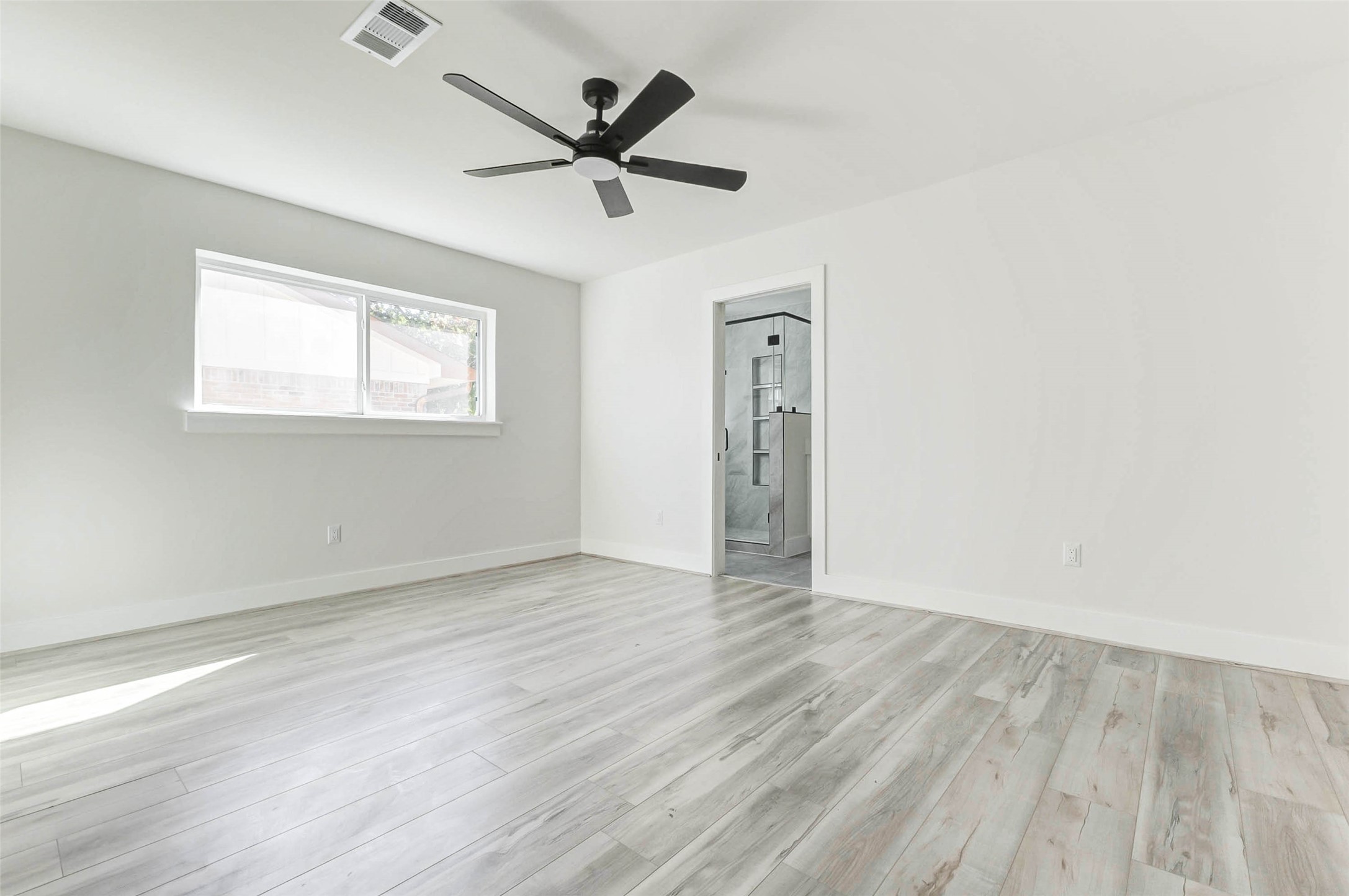 6106 Rutherglenn Drive Houston, TX 77096 - Photo 34 of 43 an empty room with wooden floor and windows