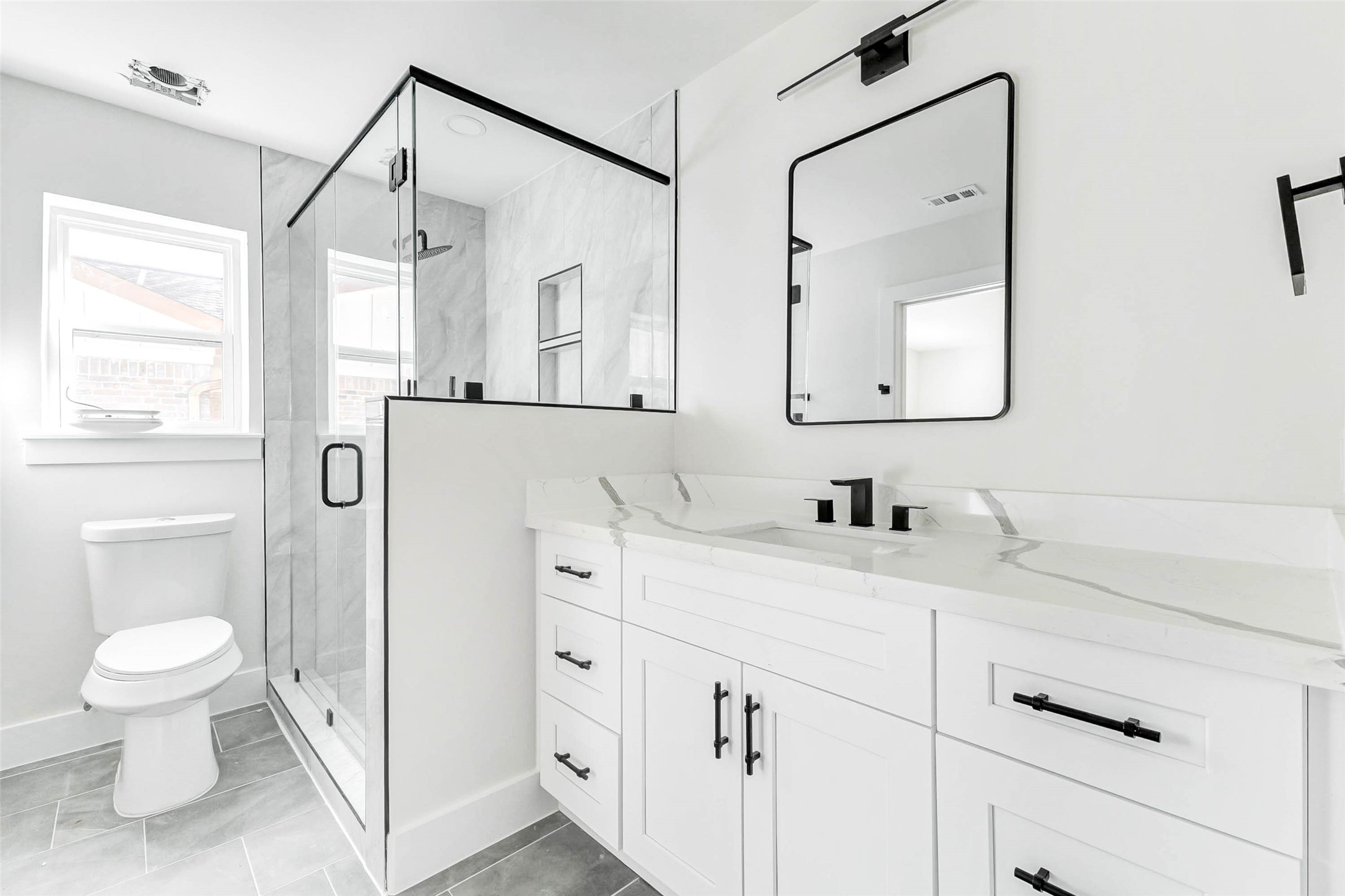 6106 Rutherglenn Drive Houston, TX 77096 - Photo 37 of 43 a bathroom with a granite countertop sink a toilet and a mirror