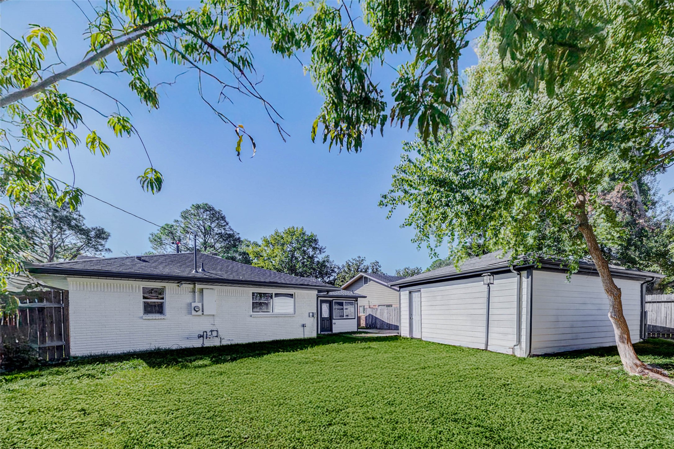 6106 Rutherglenn Drive Houston, TX 77096 - Photo 41 of 43 a view of a house with a yard and a large tree