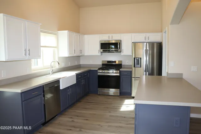 a view of wooden floor chandelier and window in a room