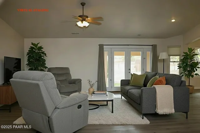 a living room with furniture potted plant and a window