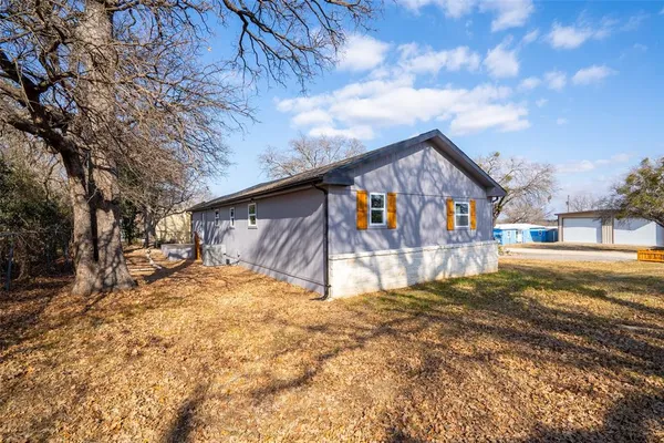 a large kitchen with stainless steel appliances granite countertop a stove a sink and a microwave