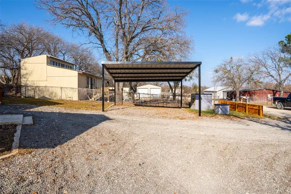 a kitchen with stainless steel appliances granite countertop a stove a sink dishwasher a microwave oven and a refrigerator with wooden floor