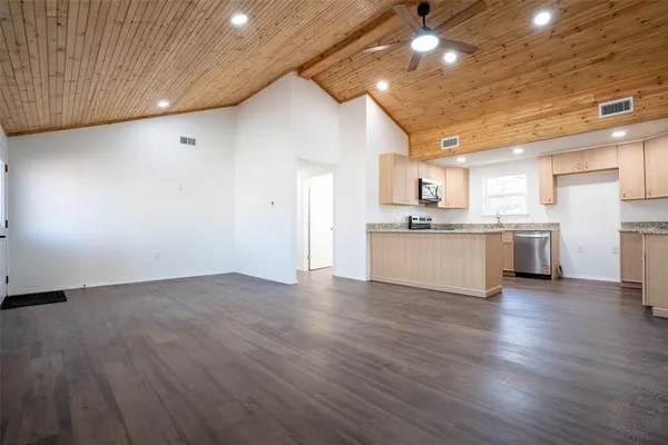 a kitchen with a sink window and cabinets