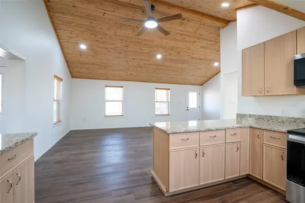 a kitchen with a sink window and cabinets
