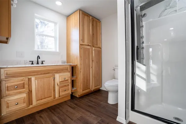 a bathroom with a glass shower door