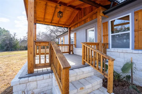 a view of balcony with wooden floor and seating space