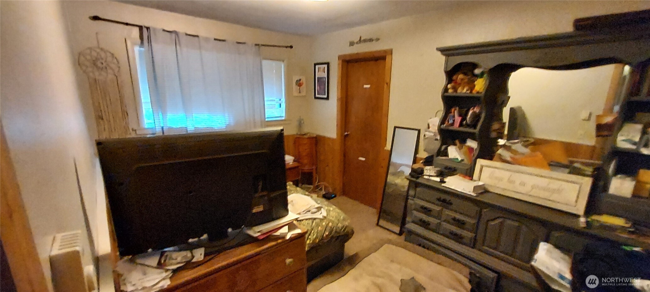 1998 Northwest Bucklin Hill Road Silverdale, WA 98383 - Photo 24 of 27 a living room with furniture a flat screen tv and a window