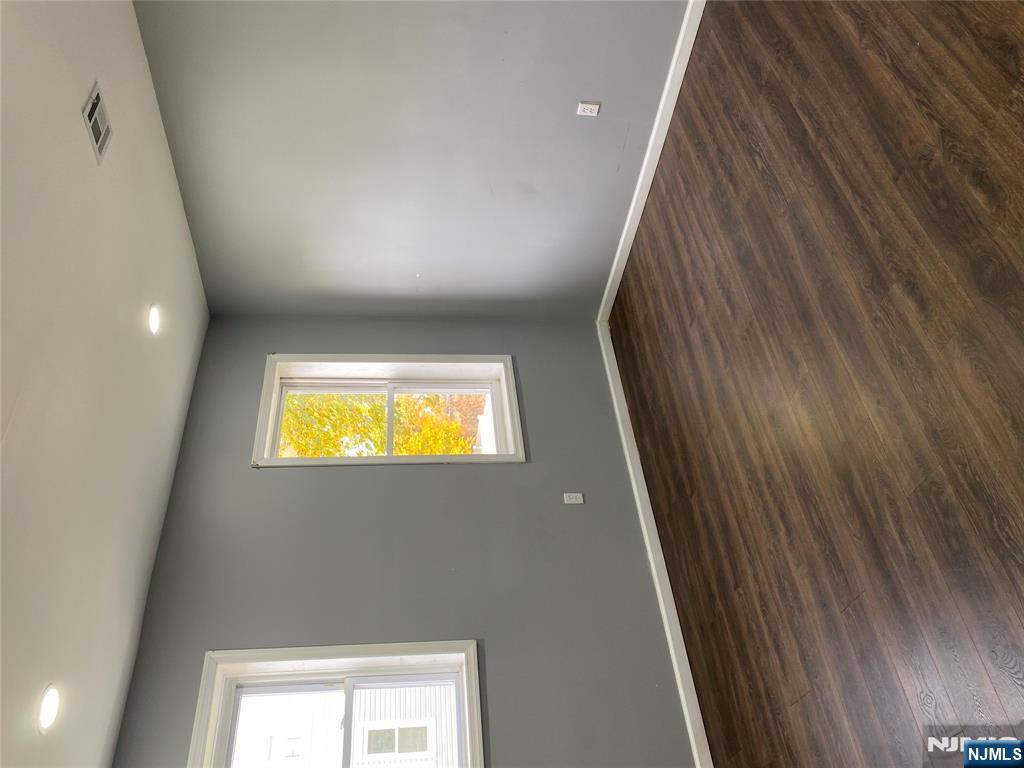 540 South 20th Street, Unit 2 Newark, NJ 07103 - Photo 12 of 13 a view of an empty room with wooden floor and a window