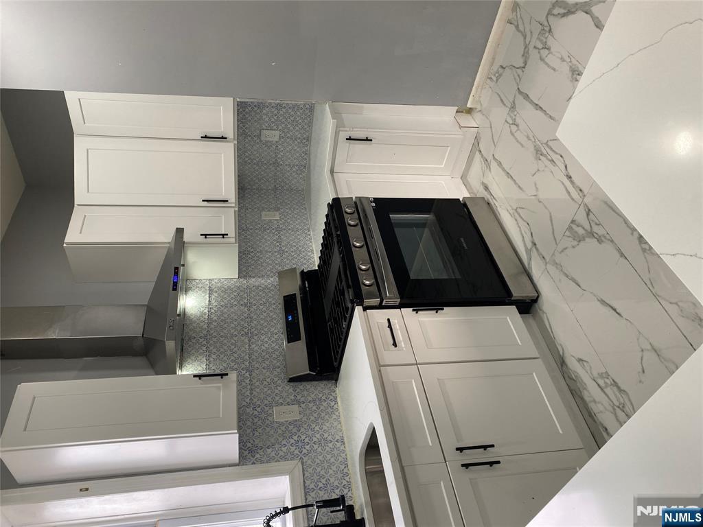 540 South 20th Street, Unit 2 Newark, NJ 07103 - Photo 3 of 13 a kitchen with a stove top oven and cabinets