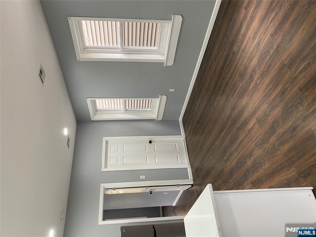 540 South 20th Street, Unit 2 Newark, NJ 07103 - Photo 5 of 13 a view of an empty room with wooden floor and a window