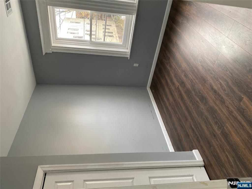 540 South 20th Street, Unit 2 Newark, NJ 07103 - Photo 10 of 13 an empty room with wooden floor and windows