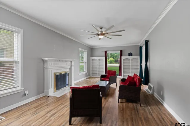 a living room with furniture and wooden floor