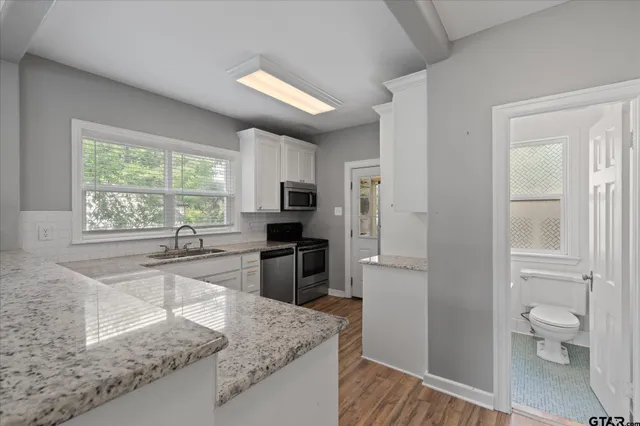 a kitchen with a refrigerator sink and stove