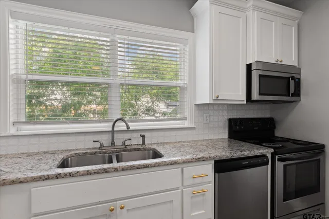 a kitchen with granite countertop a sink and a window