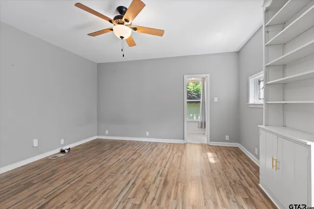 wooden floor in an empty room with a window