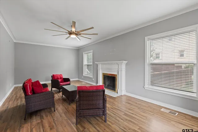 a living room with furniture and a fireplace