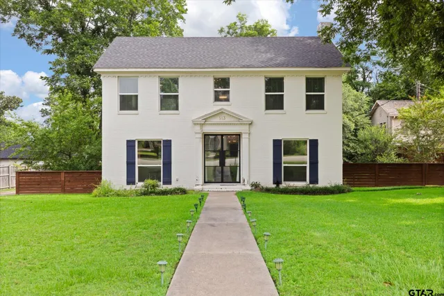 a front view of a house with garden