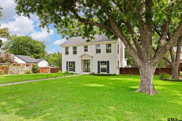 a front view of a house with a garden