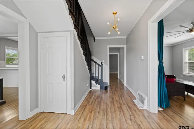 a view of entryway with wooden floor and stairs